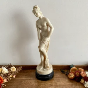 Statuette Vénus sortant du bain en résine sur socle noir en bois